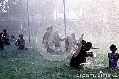 Teenage group of people enjoying holiday in water park. Editorial Stock Photo